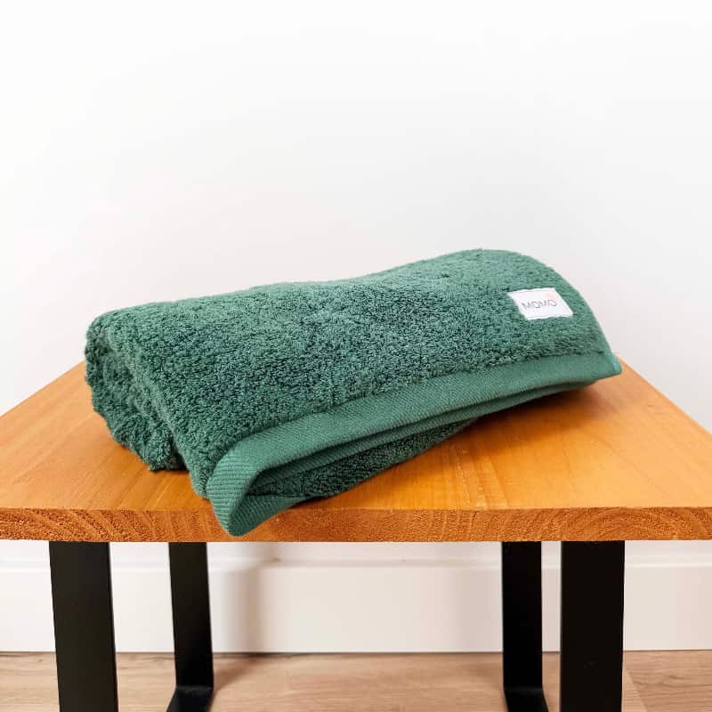 Green bamboo hand towel on bench – soft, absorbent and gentle on the skin