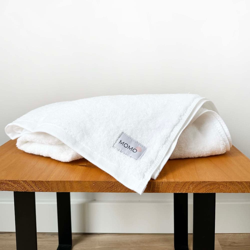 White bamboo hand towel on bench – soft, absorbent and sustainable