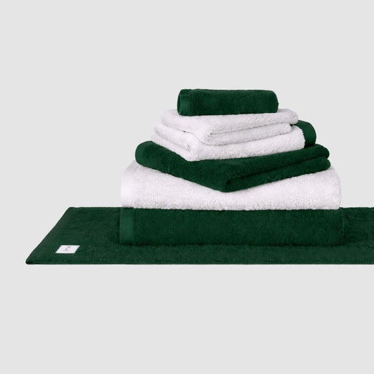 Conjunto de toalhas Wabi Sabi em branco e verde floresta empilhado contra fundo neutro