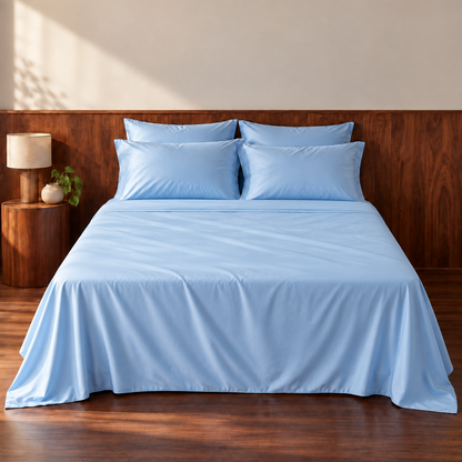 Light blue top sheet on wooden bed with matching pillows in modern bedroom