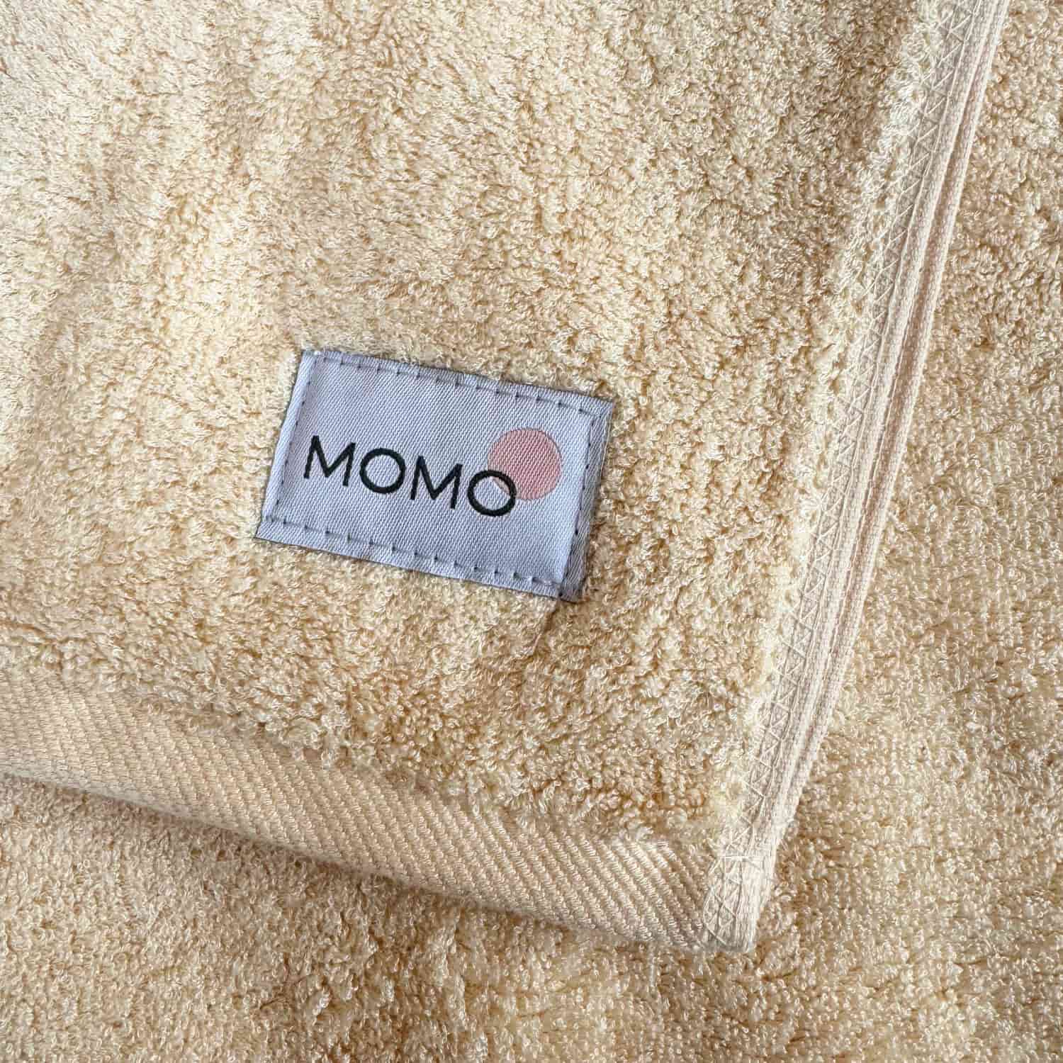 Beige bamboo towel with Momo logo – soft, absorbent and sustainable
