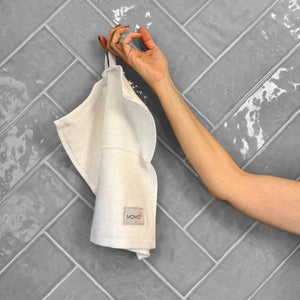 White bamboo washcloth on grey background – soft, absorbent and sustainable